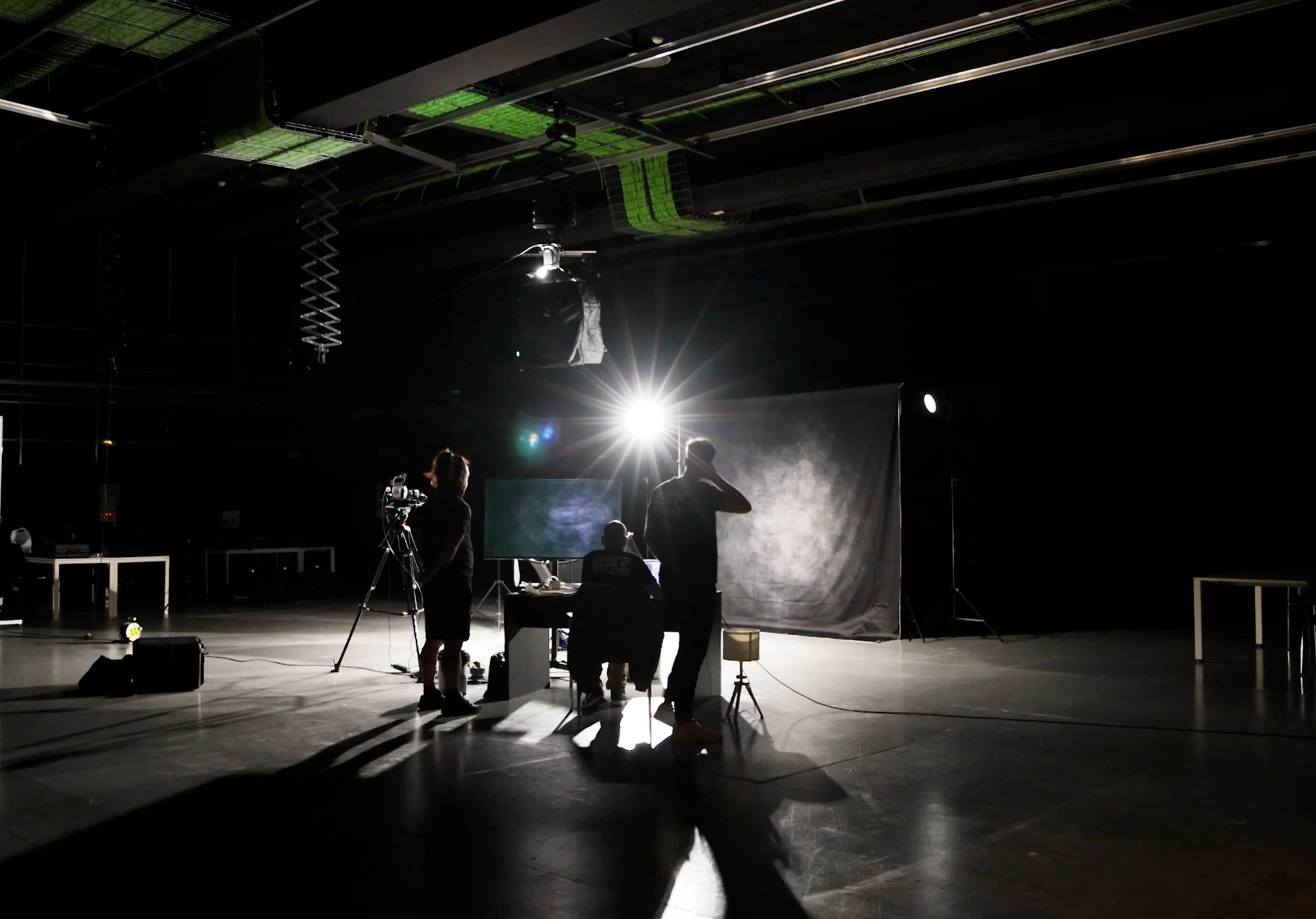 Behind the scenes of a training video production, with crew, camera and studio lighting